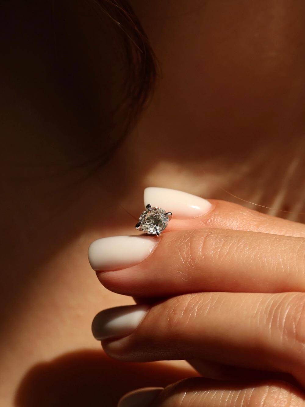 Round Brilliant Stud Earrings detail on hand