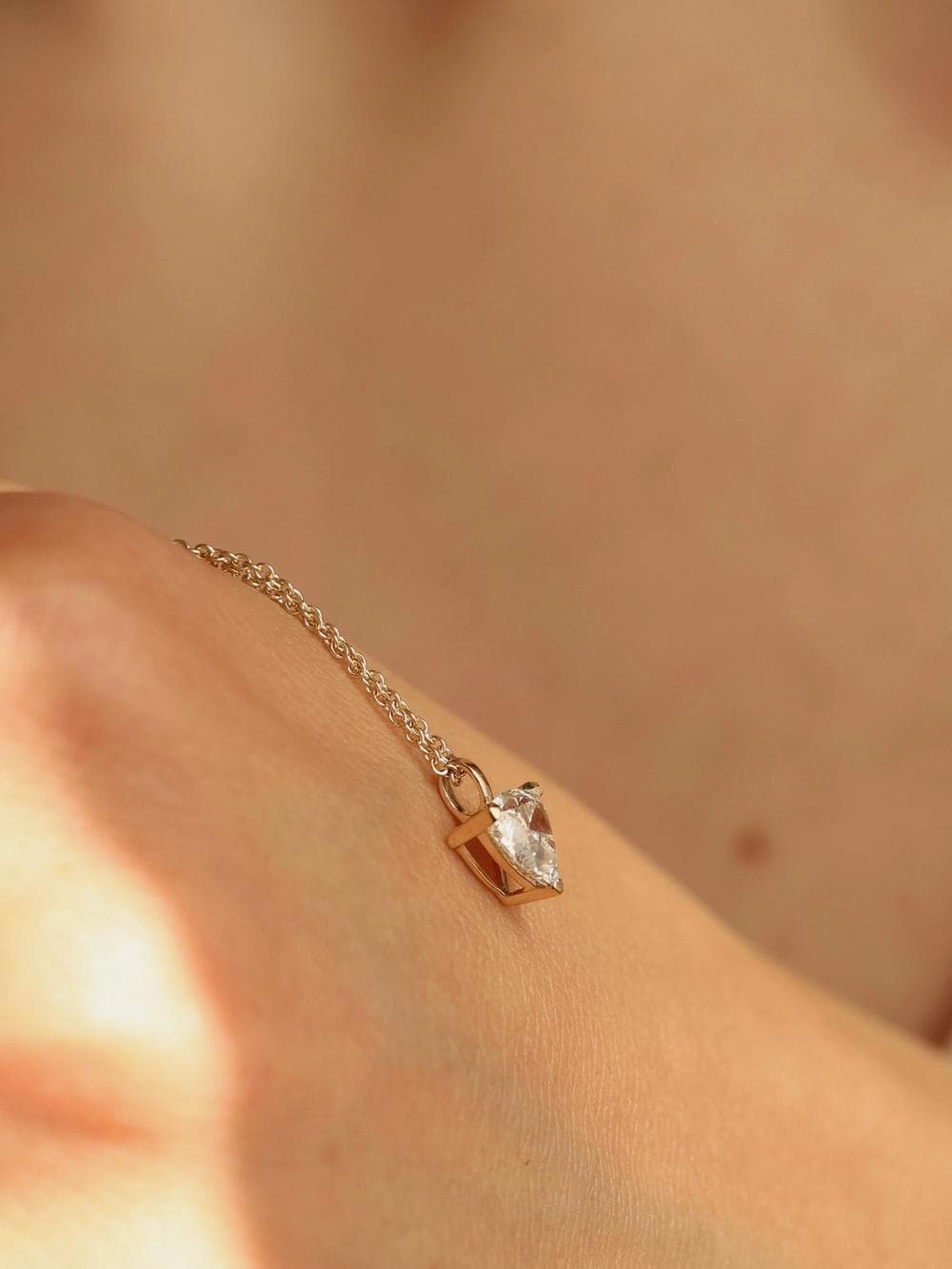 Trillion Cut Pendant held in hand