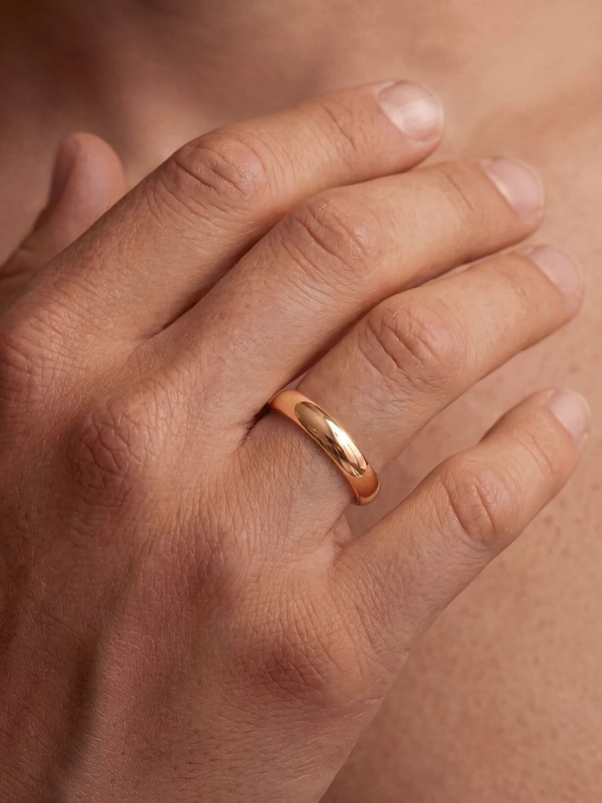 Classic 5 mm half-round wedding ring on man's hand