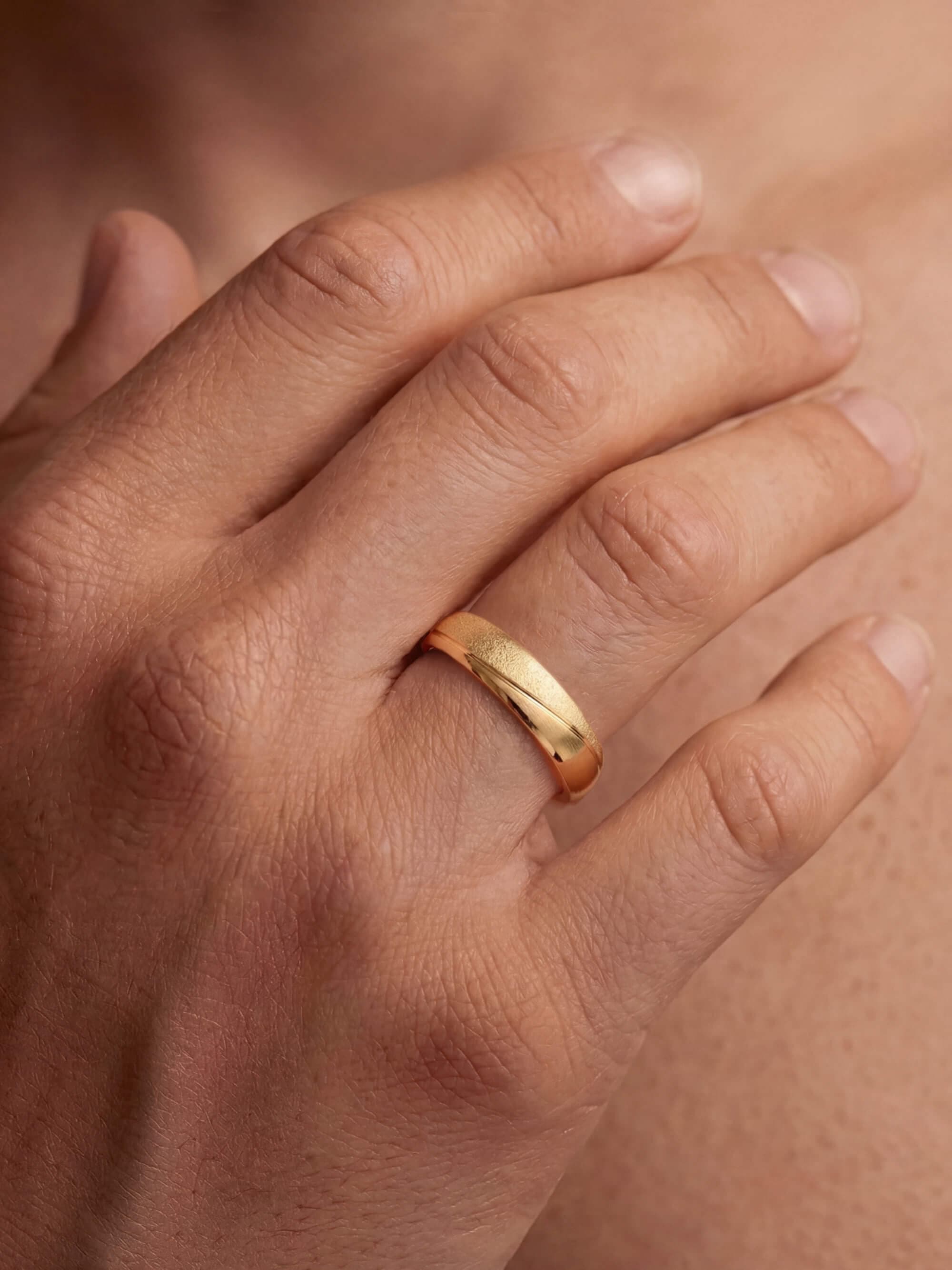 Waves wedding ring on man's hand